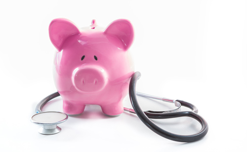 A pink piggy bank with a stethoscope wrapped around it, symbolizing financial health or healthcare savings, on a white background.